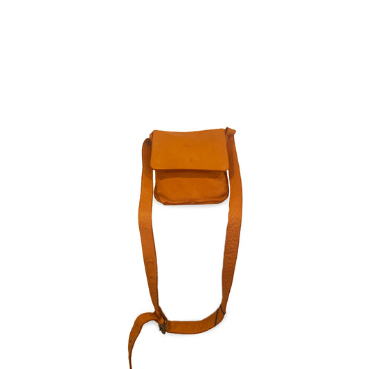 Orange leather crossbody bag on a white background